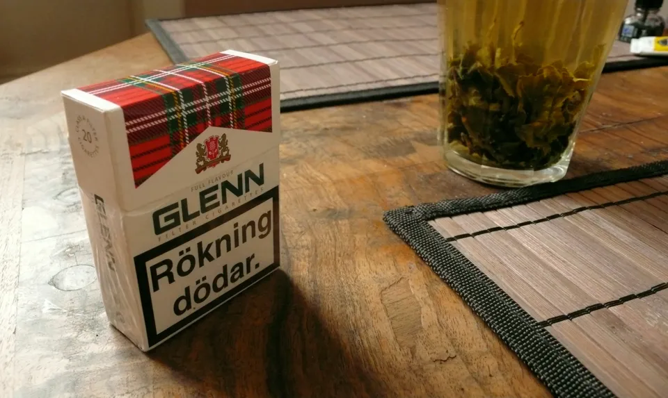 Pack of cigarettes and a cup of loose tea